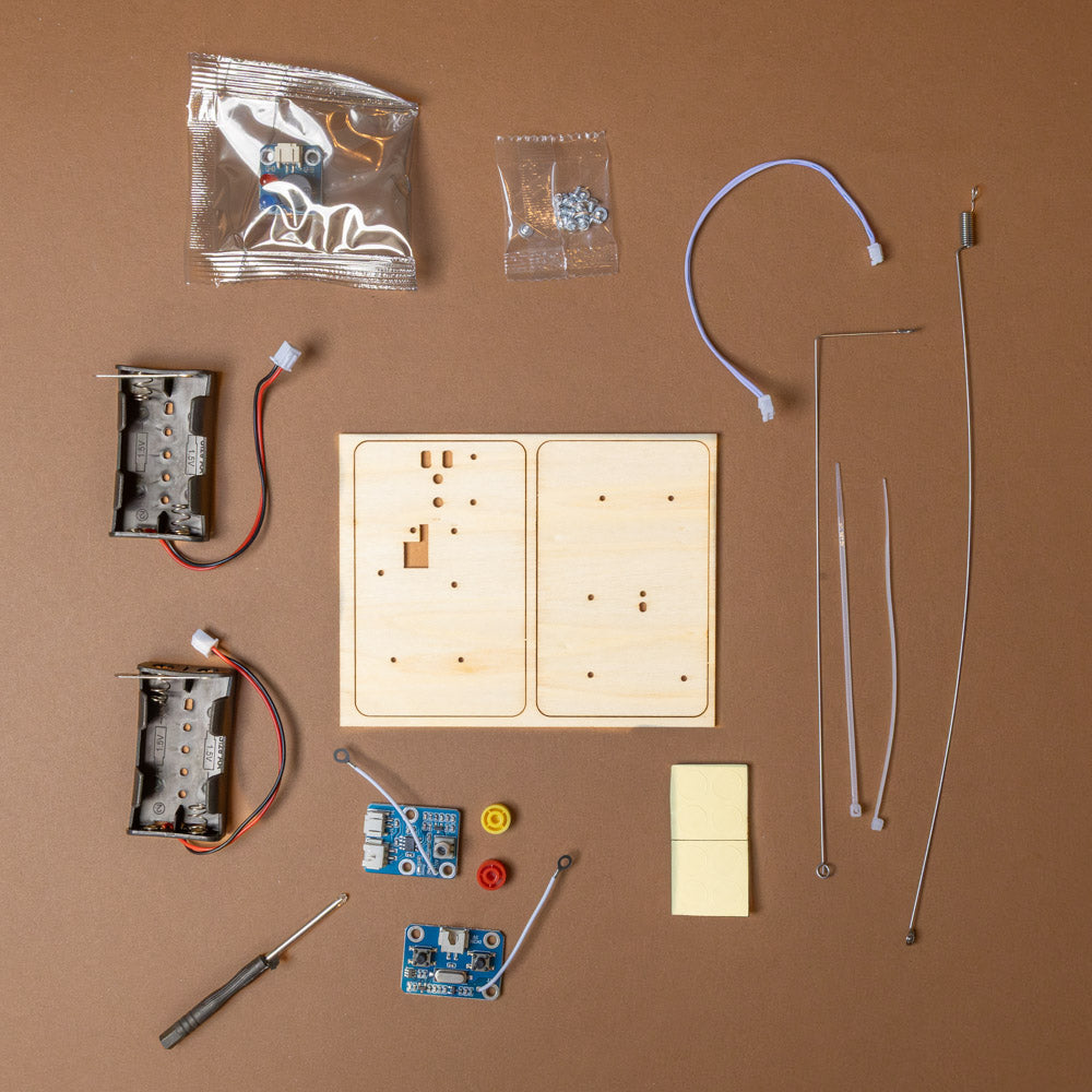 make-your-own-telegraph-and-morse-code-kit Collection of electronic components and tools on a brown background