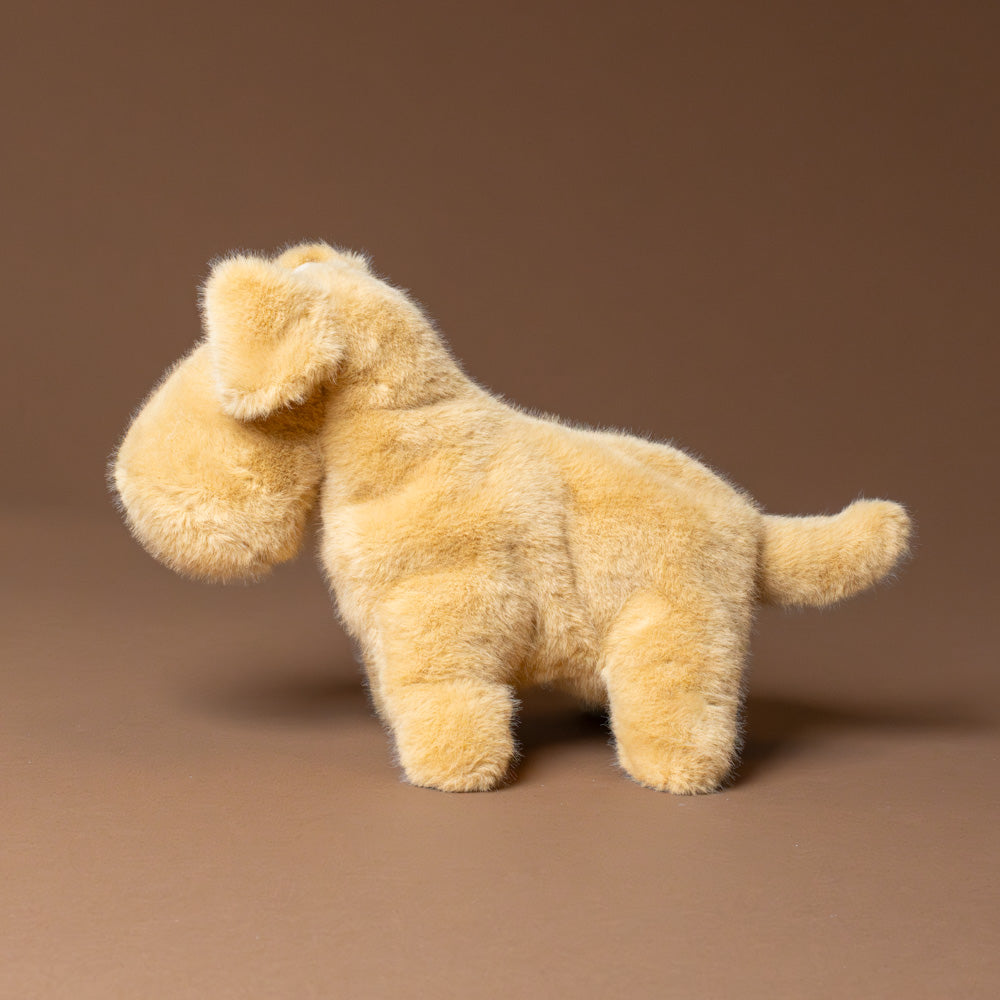 muzzle-tim-tan-pup Plush dog toy on a brown background