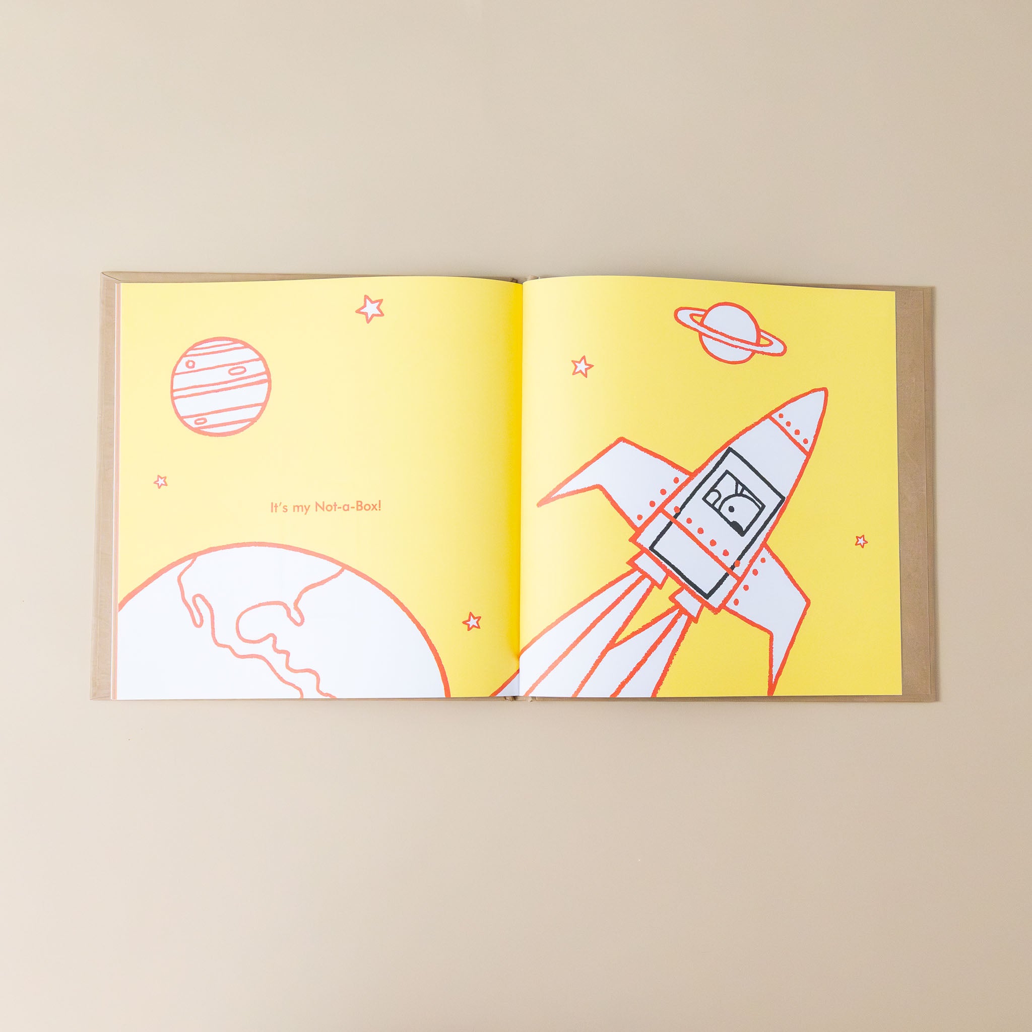 not-a-box-book-cover-interior-page-of-rabbit-in-black-square-while-colorful-illustration-of-rocket-blasting-into-space-and-text-it-is-not-a-box