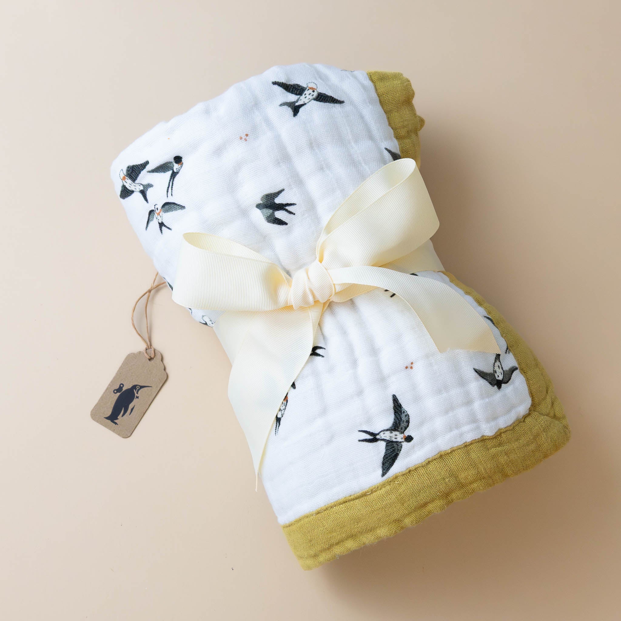 organic-cotton-muslin-blanket-swallows-with-ochre-trim