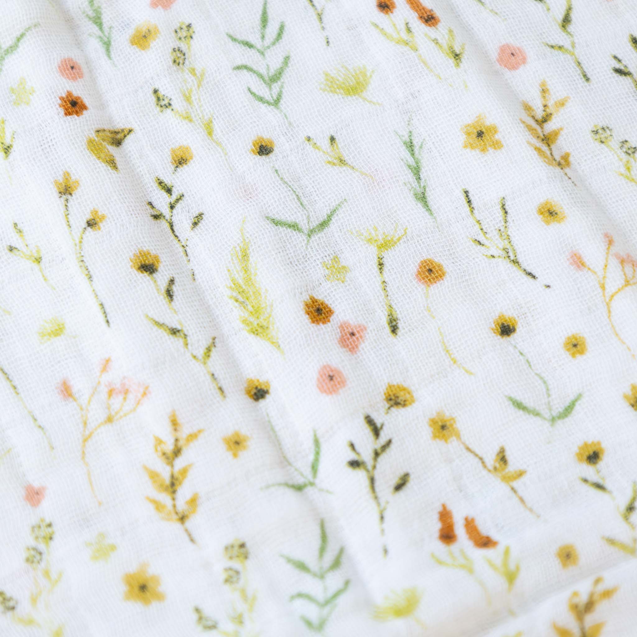 organic-cotton-muslin-swaddle-floral-field-detail-in-blush-orange-and-green