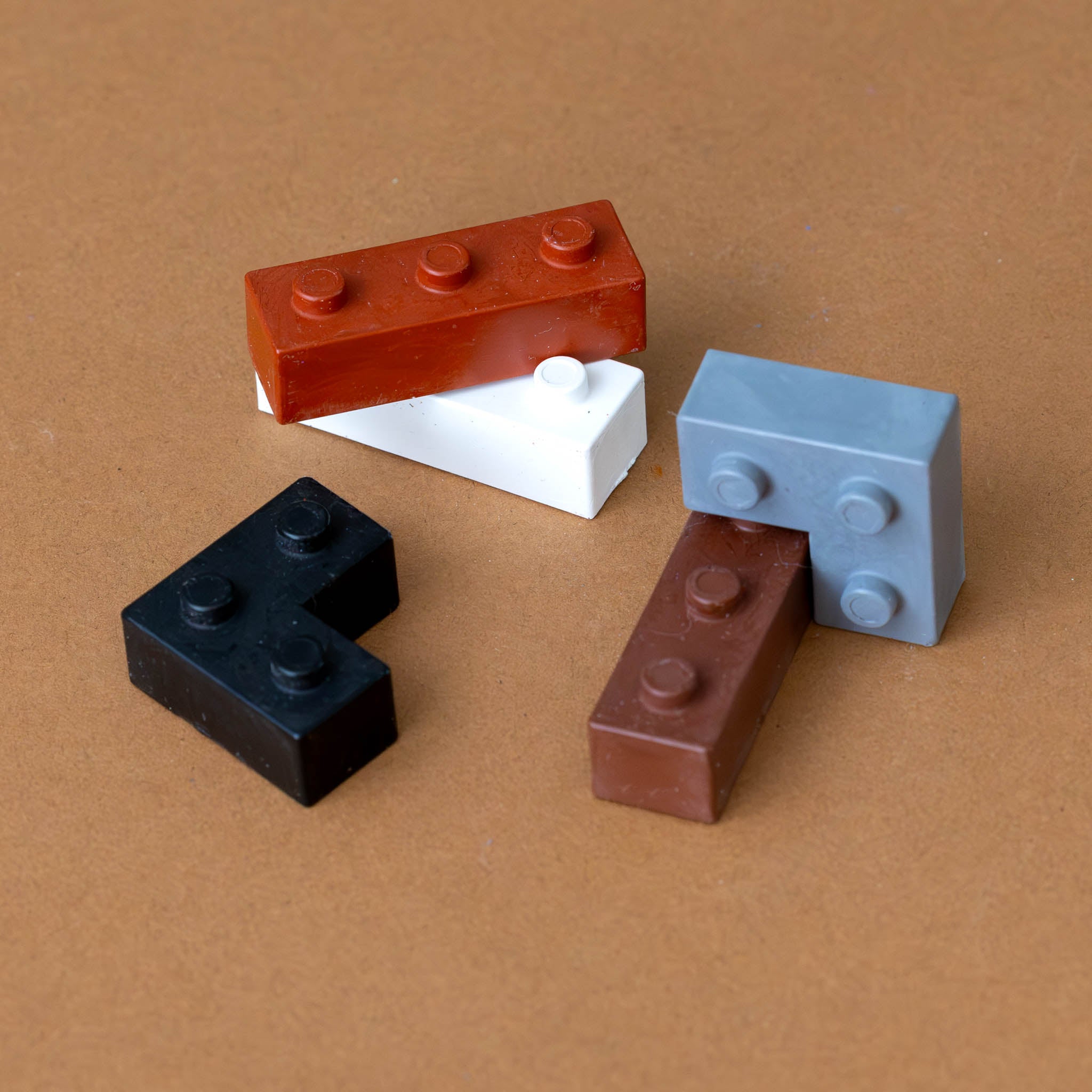 pocket-5-crayons-warm-grey-shaped-like-building-blocks-in-grey-black-and-browns--stacked