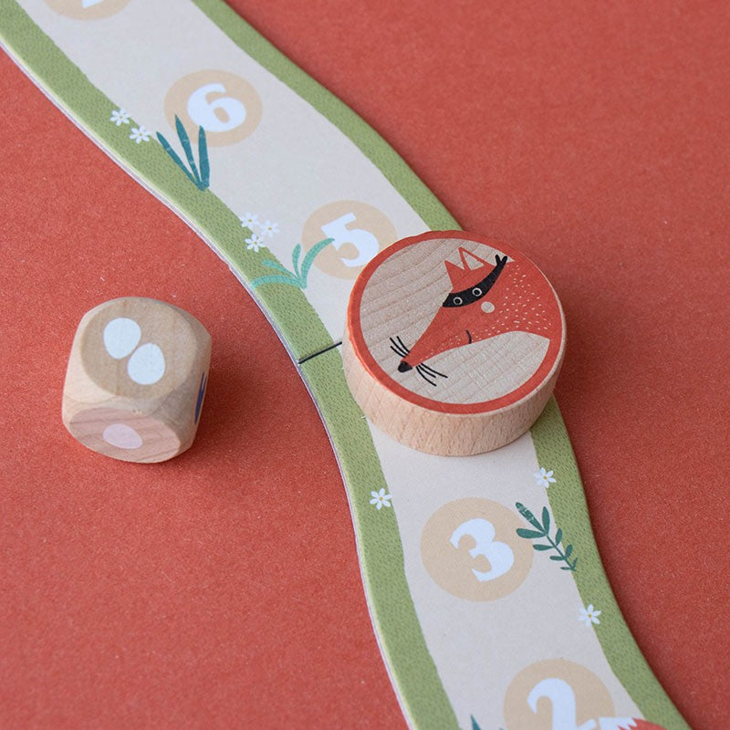pocket-game-cluck-cluck-the-fox Wooden dice and fox game piece on a colorful game board with numbers and animal illustrations.