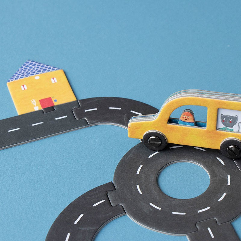 pocket-game-roads Toy car on a paper road with a house and bridge on a blue background