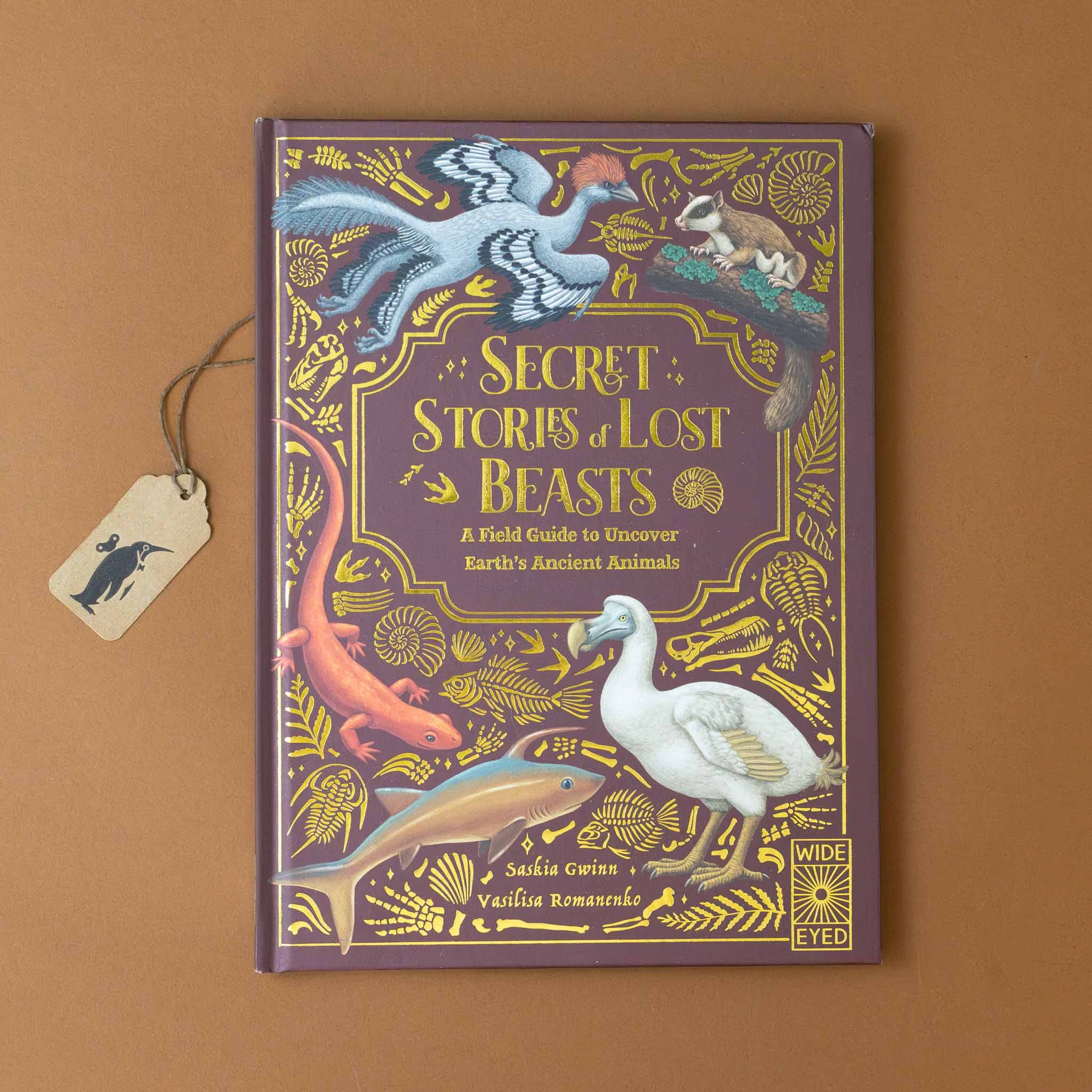 secret-stories-of-lost-beasts-purple-cover-with-different-creatures-amongst-gold-foil-lettering-and-natures-shapes