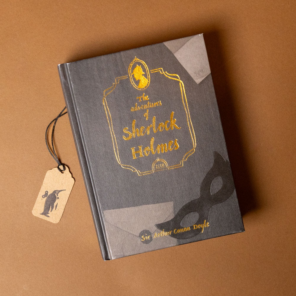 Book titled 'The Adventures of Sherlock Holmes' with a tag on a brown background