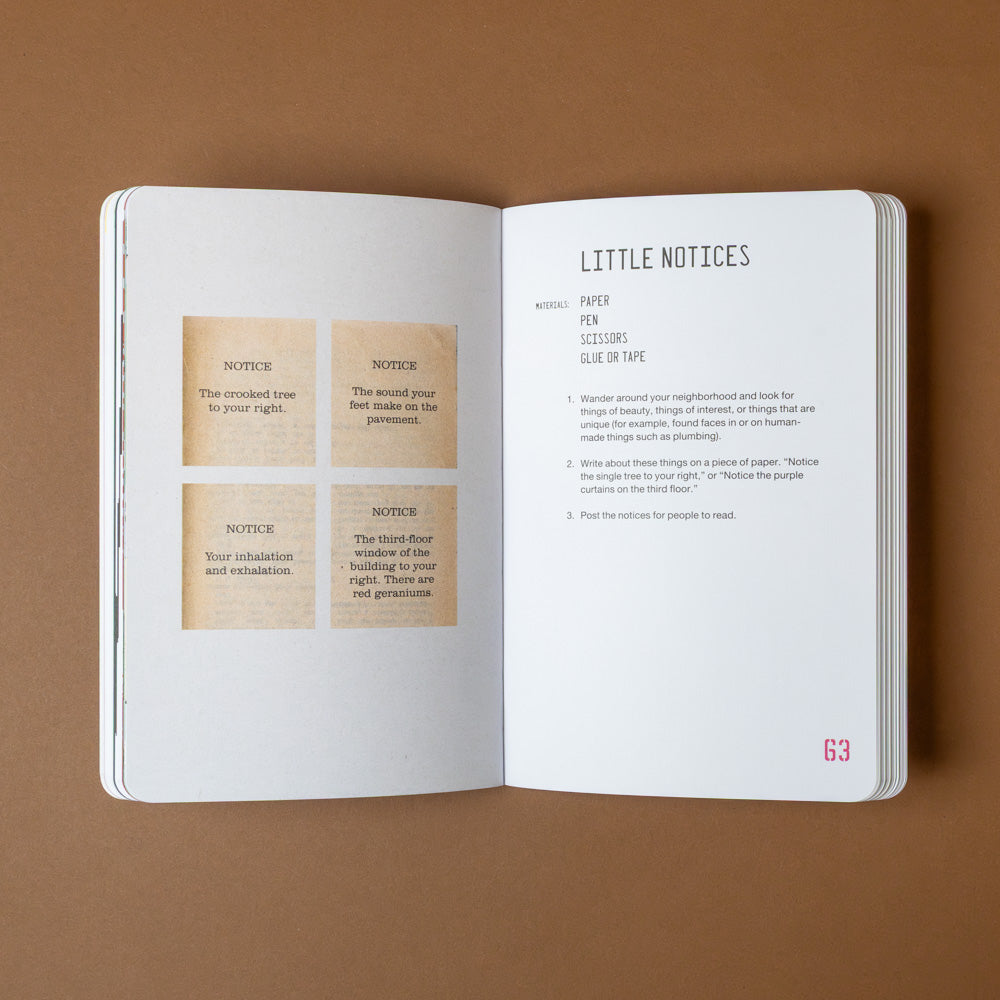 the-guerilla-art-guide Open book with printed text and small cards on a brown background