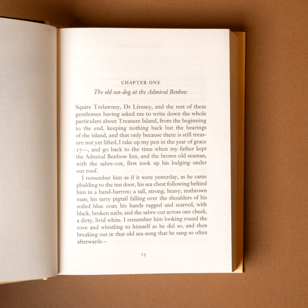 treasure-island- Open book with text on a brown background