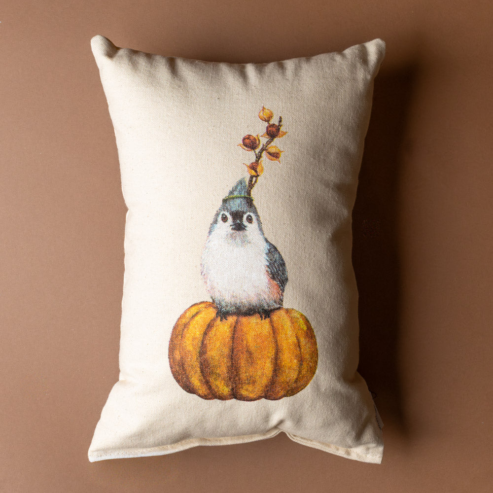 tufted-titmouse-pillow Decorative pillow with a bird and pumpkin design on a brown background
