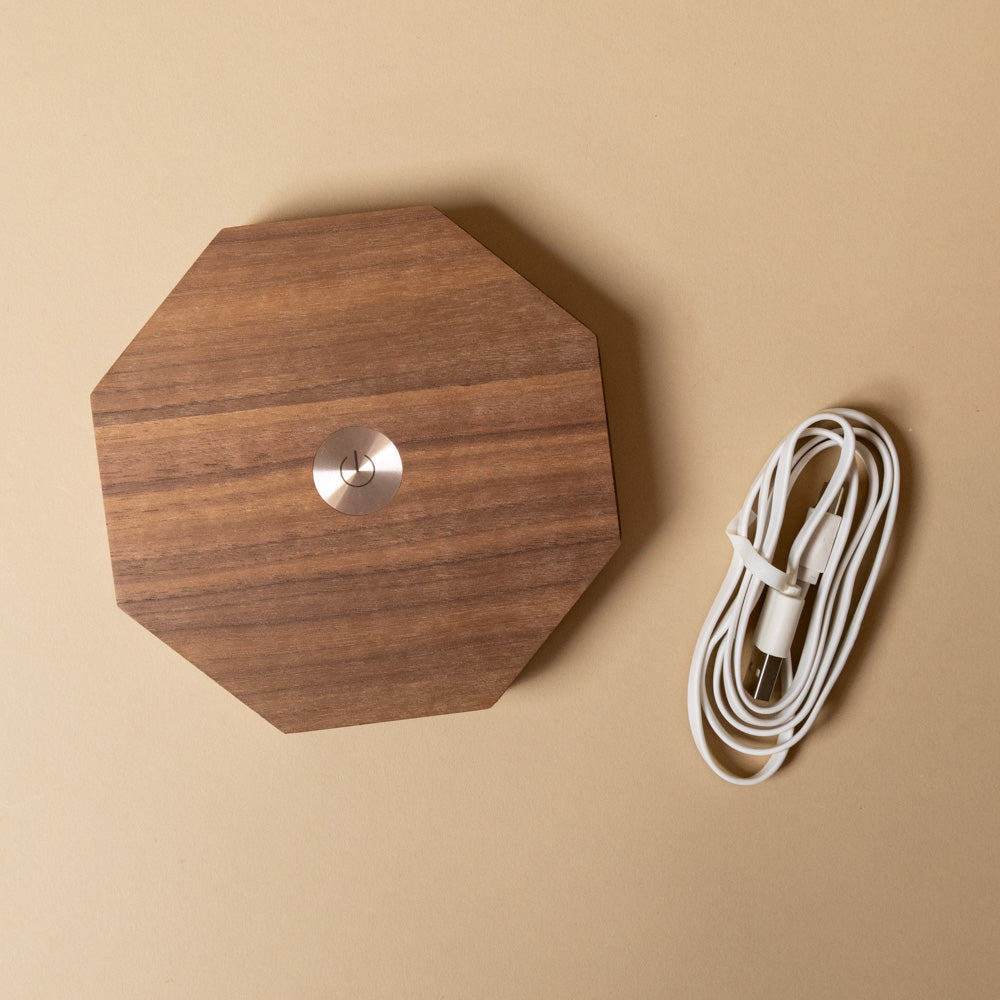 wooden-hexagon-twist-lamp-walnut with a cable on a beige background