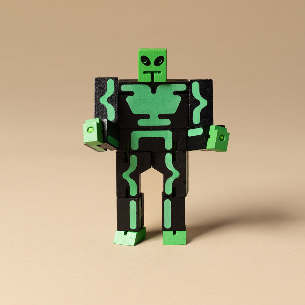 wooden-micro-cubebot-space-buddies-set Toy figure with green and black design on a beige background