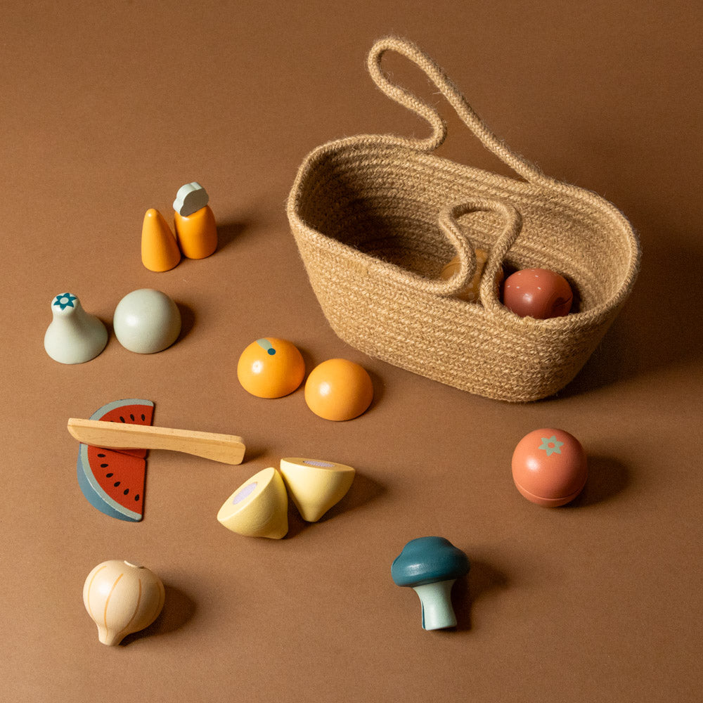 wooden-pretend-play-fruits-and-vegetables-to-cut-in-natural--shopping-tote Set of colorful wooden toys including a basket on a brown background