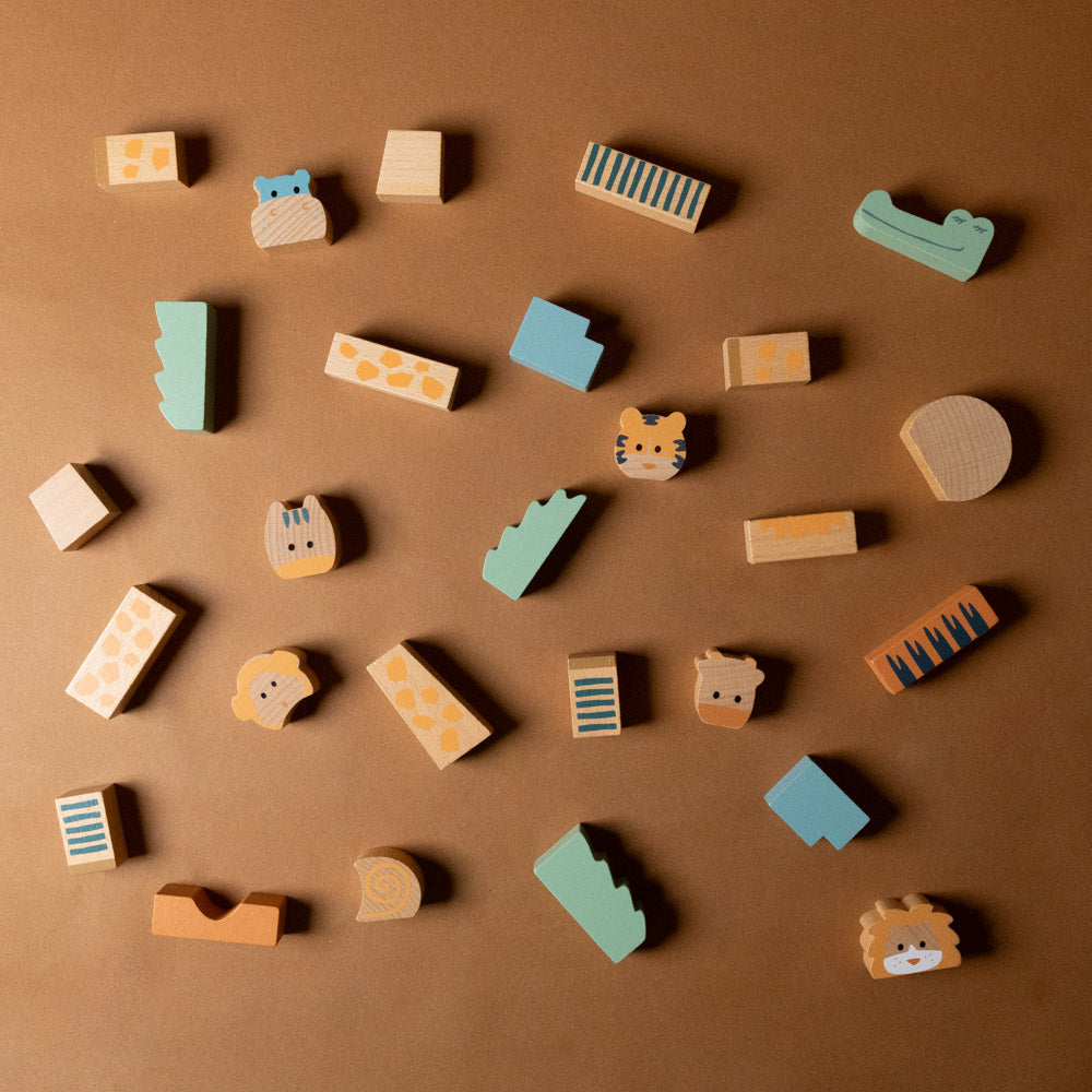 wooden-stacking-block-animals-jungle Collection of small wooden animals with various shapes and colors on a brown background