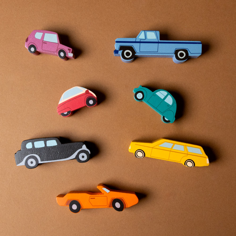 wooden-stacking-cars-play-set Colorful toy cars on a brown background