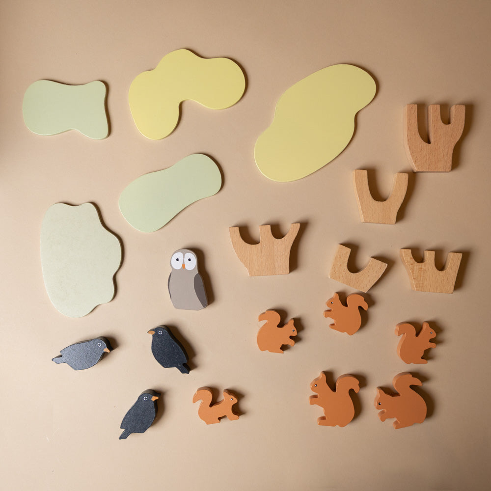wooden-stacking-squirrels-game Set of wooden animal and plant-shaped toys on a beige background