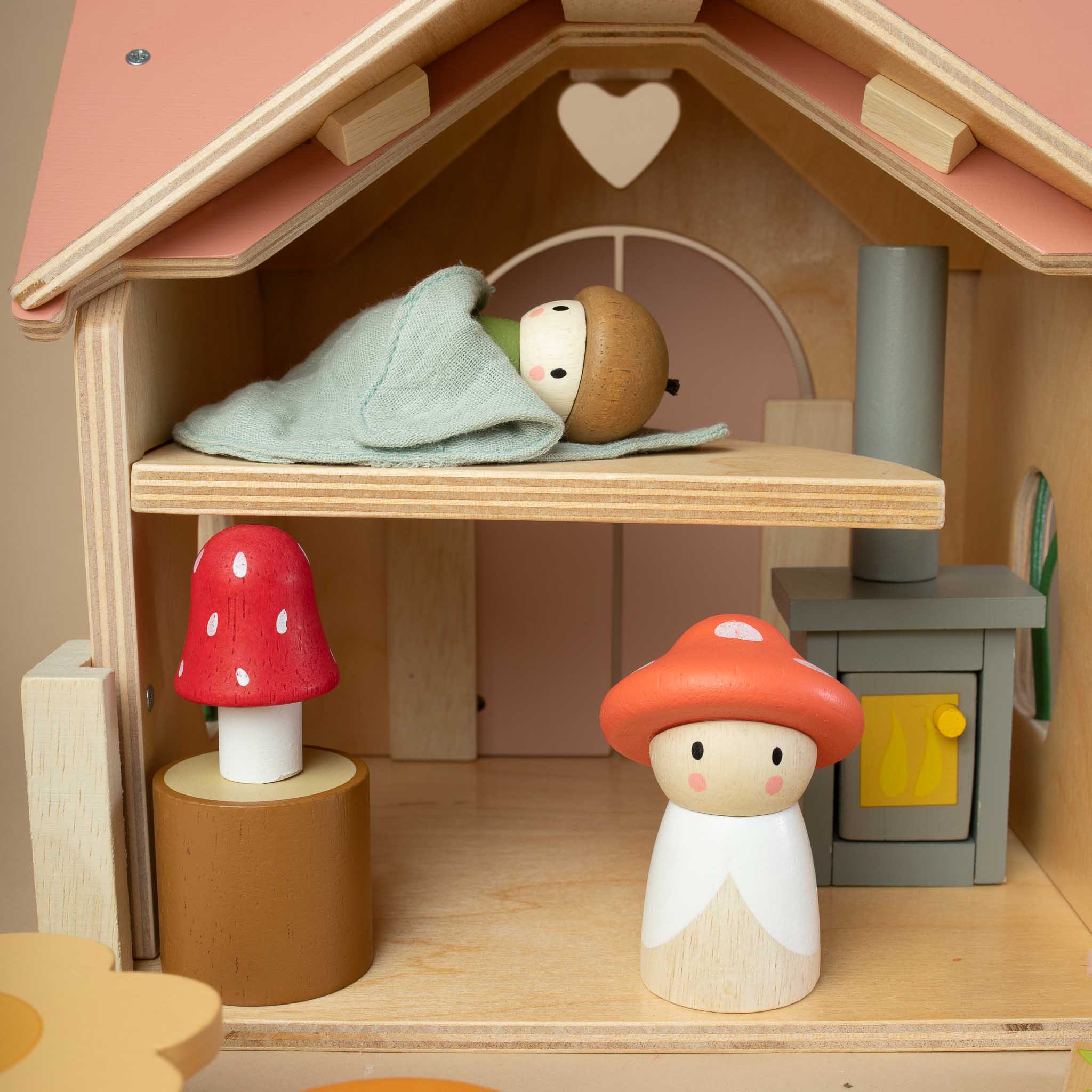 detail-of-wooden-house-and-sleeping-baby-mushroom-in-a-sleeping-bag